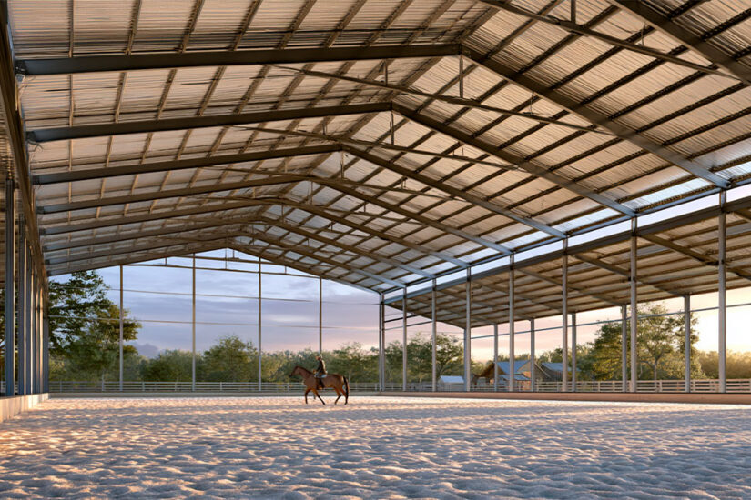 Covered outdoor riding arena with open sides and steel roof over prepared footing