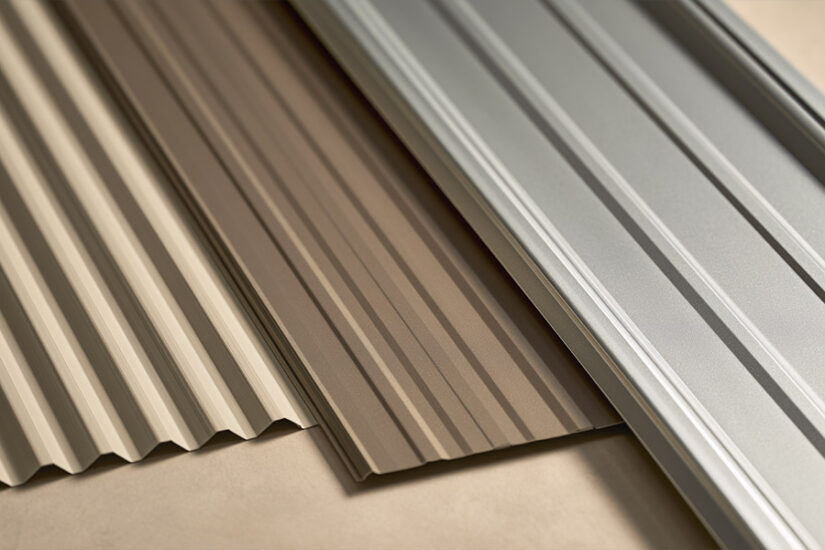 Three metal roof panel types side by side: exposed-fastener corrugated panel, 5V-crimp panel, and concealed-fastener standing seam panel