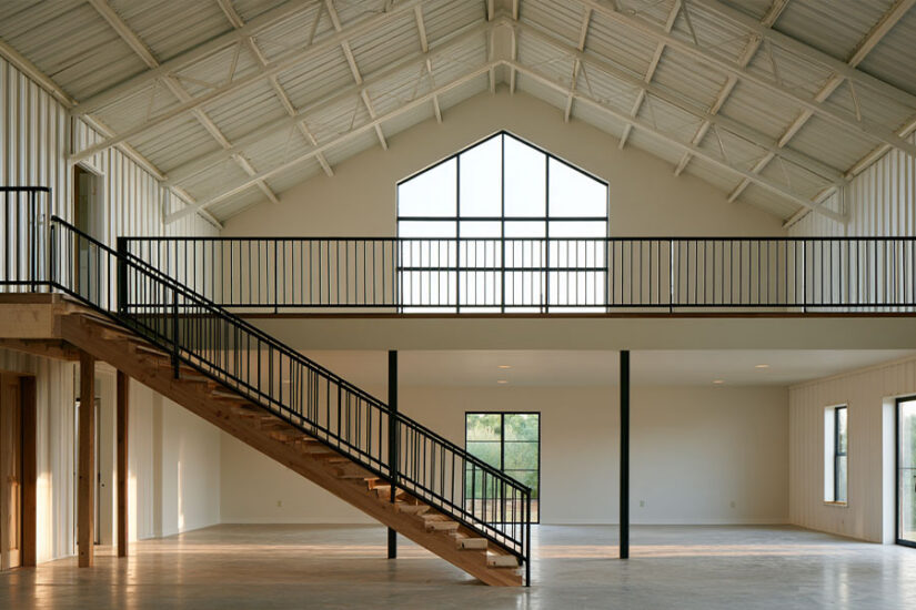 Barndominium loft ideas: open mezzanine bedroom under a steel roof frame