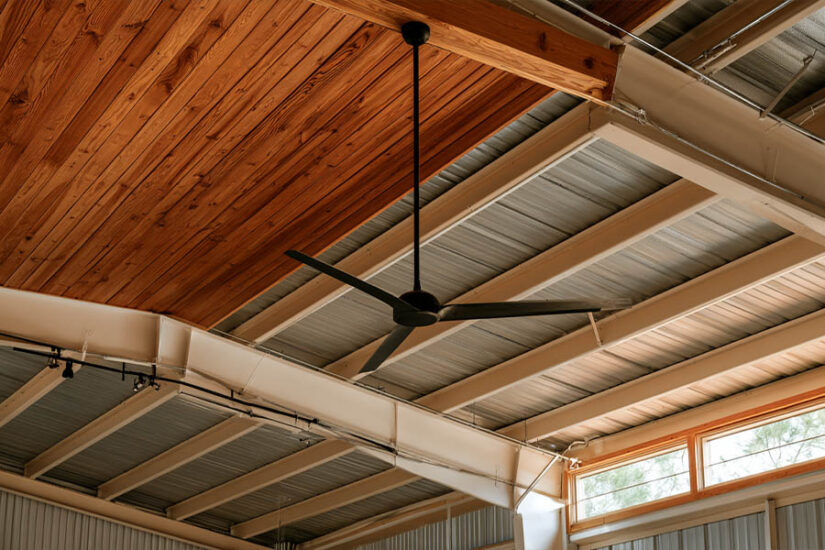 Barndominium ceiling ideas: wood-clad and exposed steel sections under one roof